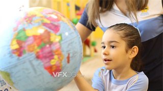 实拍视频学校老师教导学生如何观看使用地球仪