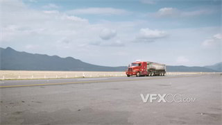 实拍视频远景拍摄橙色重型货车行驶在道路上
